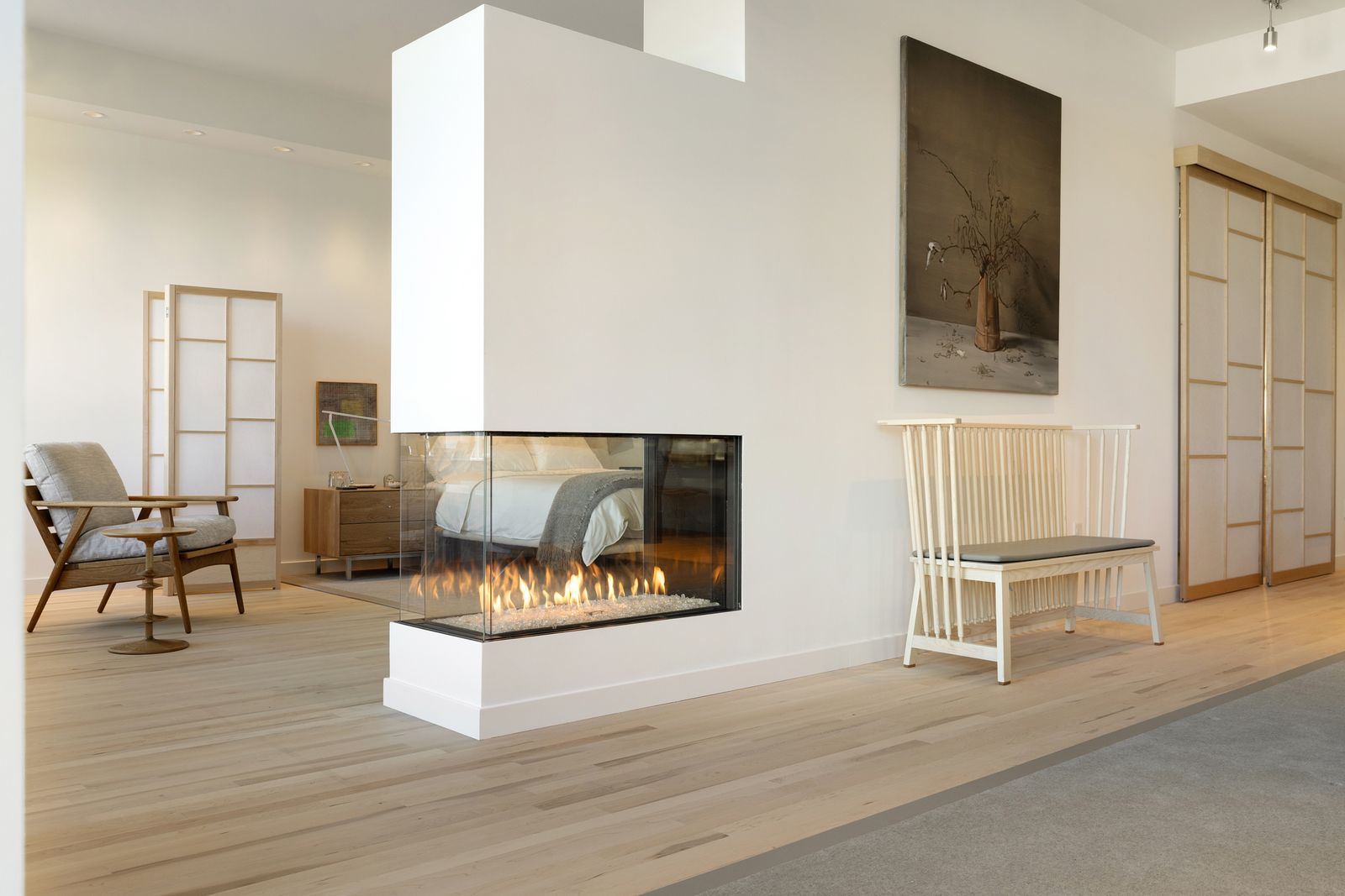 Three-sided fireplace wall in a white living room