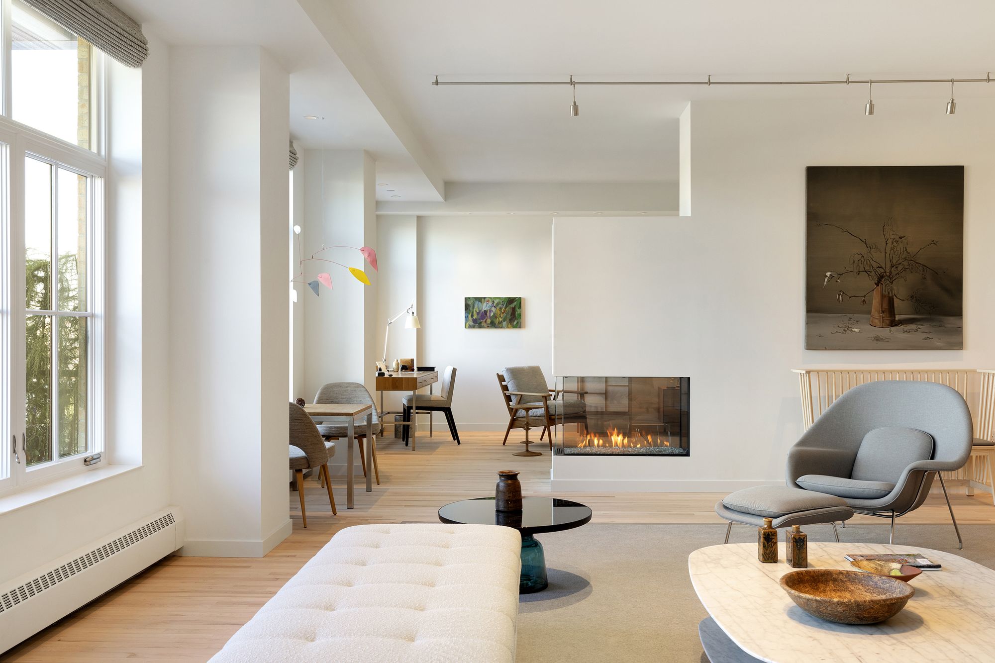 Living room with tall windows and white oak floors