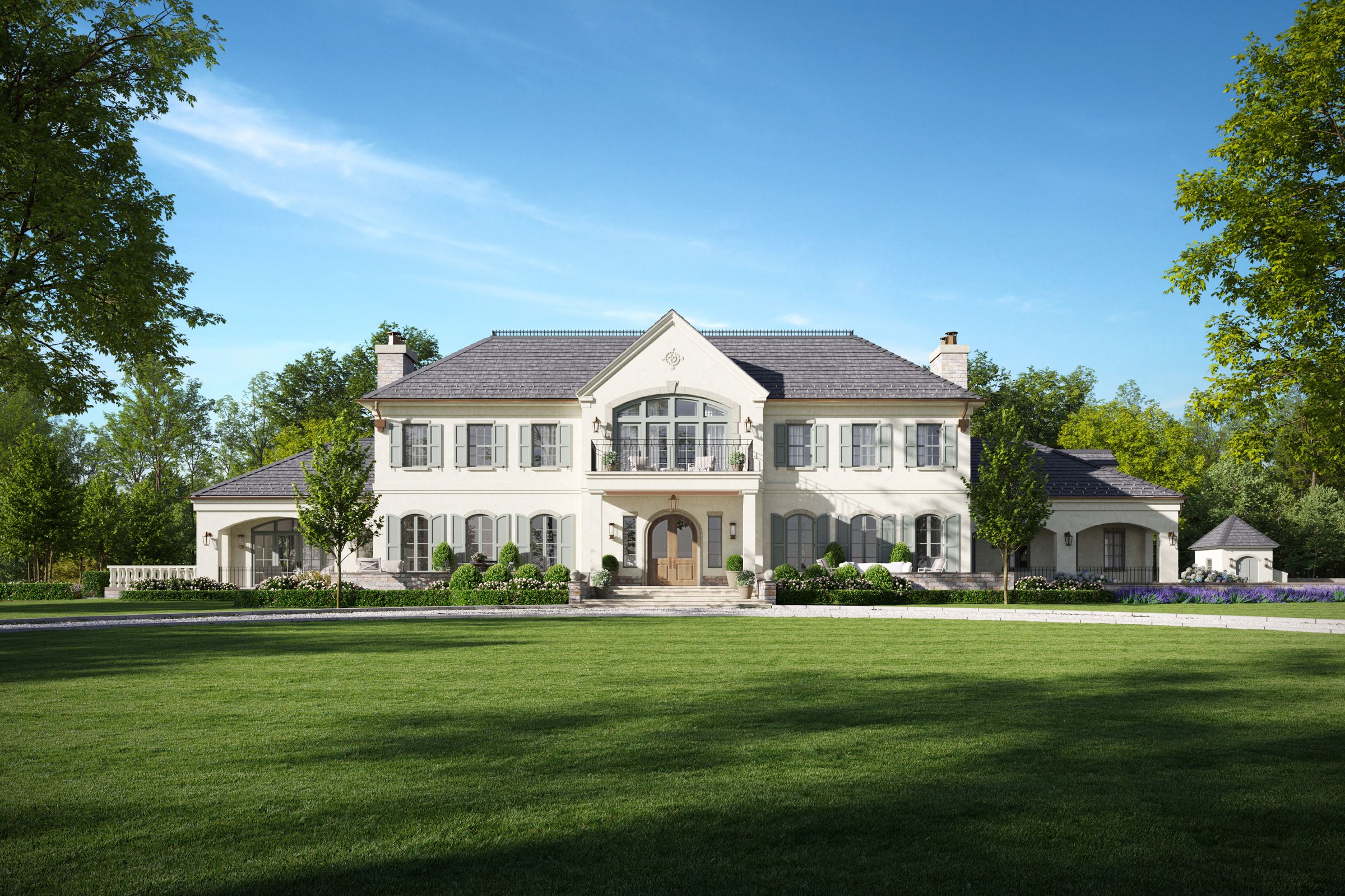 A stone and plaster French country house on a broad lawn